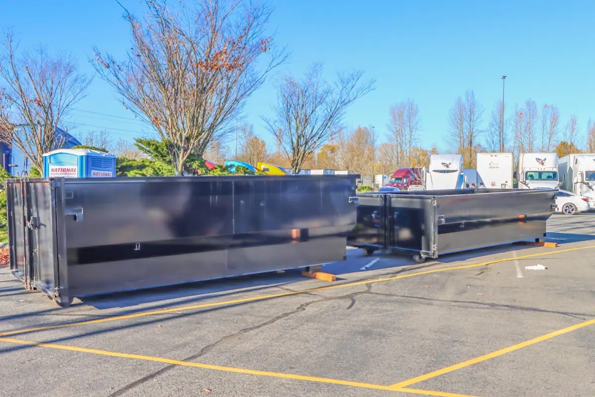 Professional dumpster rental service with roll-off container on residential driveway in Plainsboro